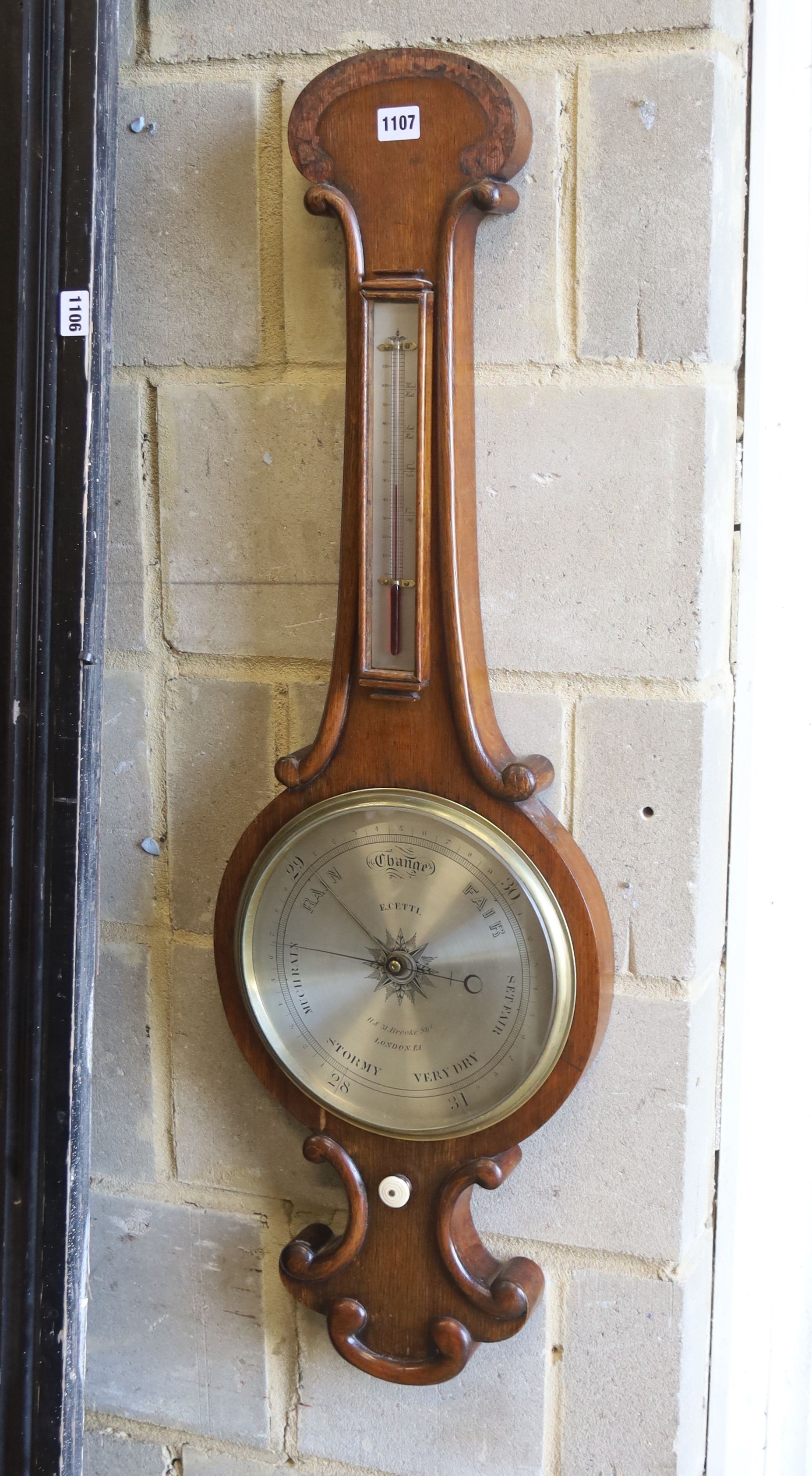A Victorian oak cased wheel barometer and thermometer by E. Setti, Brooke Street, London, height 102cm